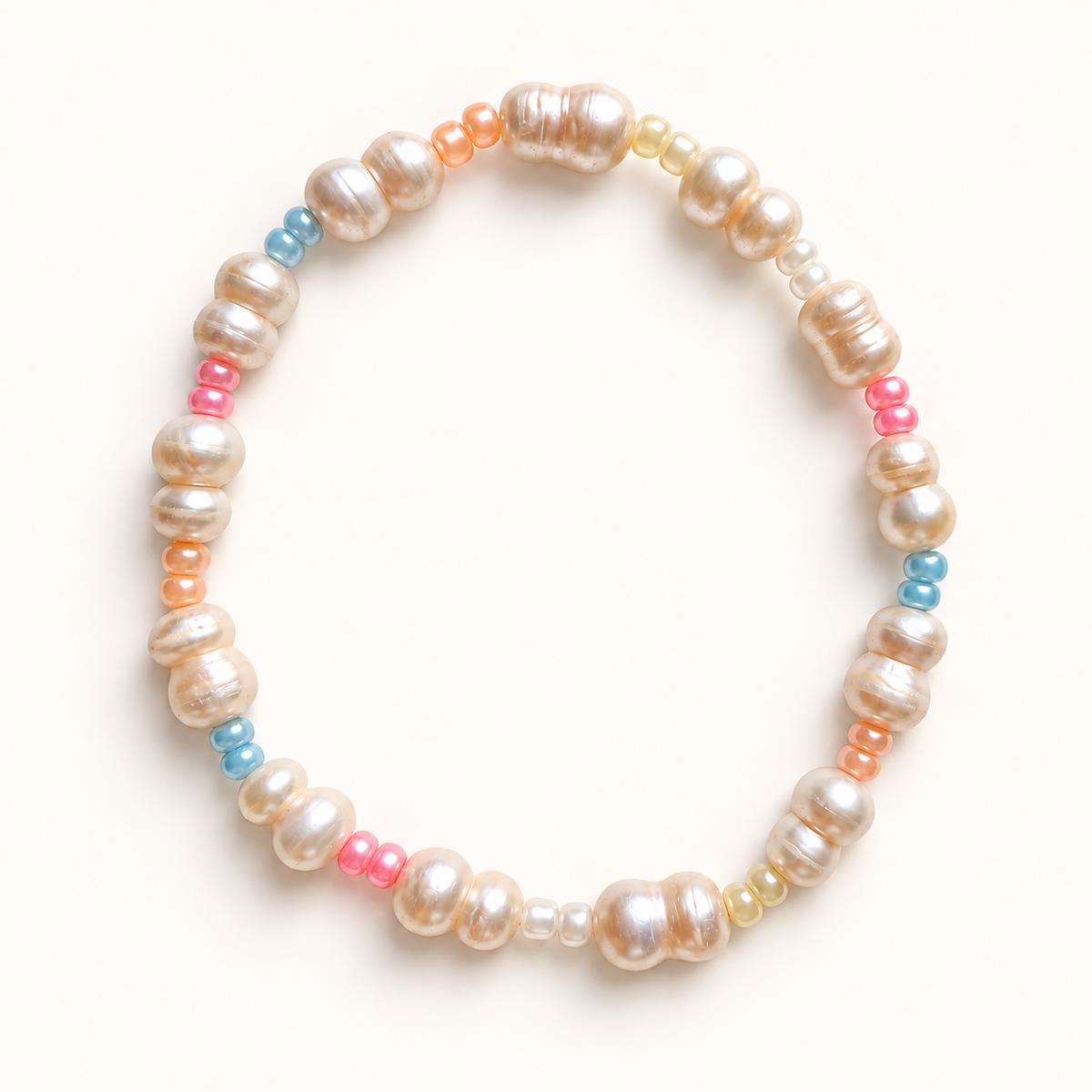 Daughter pearl stretch anklet with pastel multicolor beads on a warm ivory background