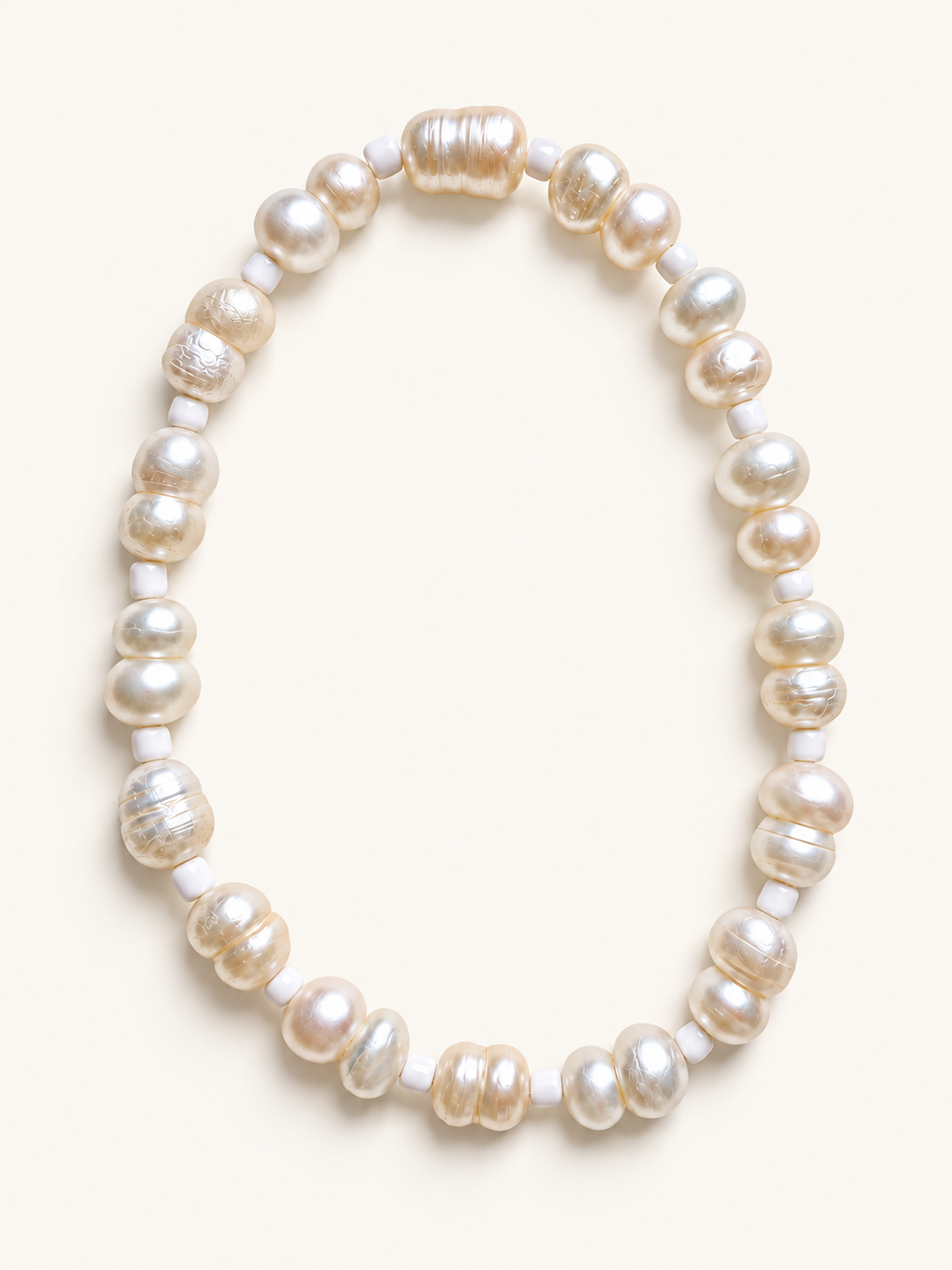 Freshwater pearl stretch anklet with white bead accents on a cream background